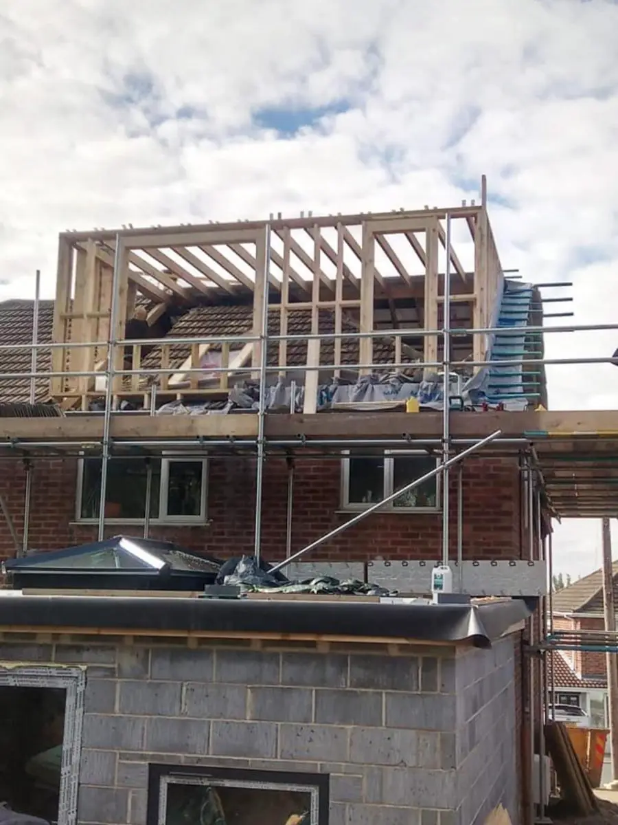 Dormer frame going up on a rear roof with scaffold in place