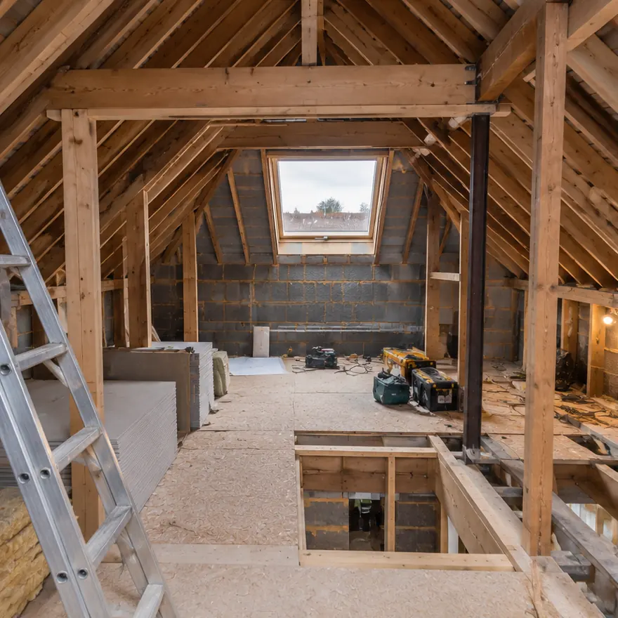 Loft space being framed, with a roof window and steel in place